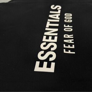 Fear of God Essentials Black Tee with White Care Tag Print